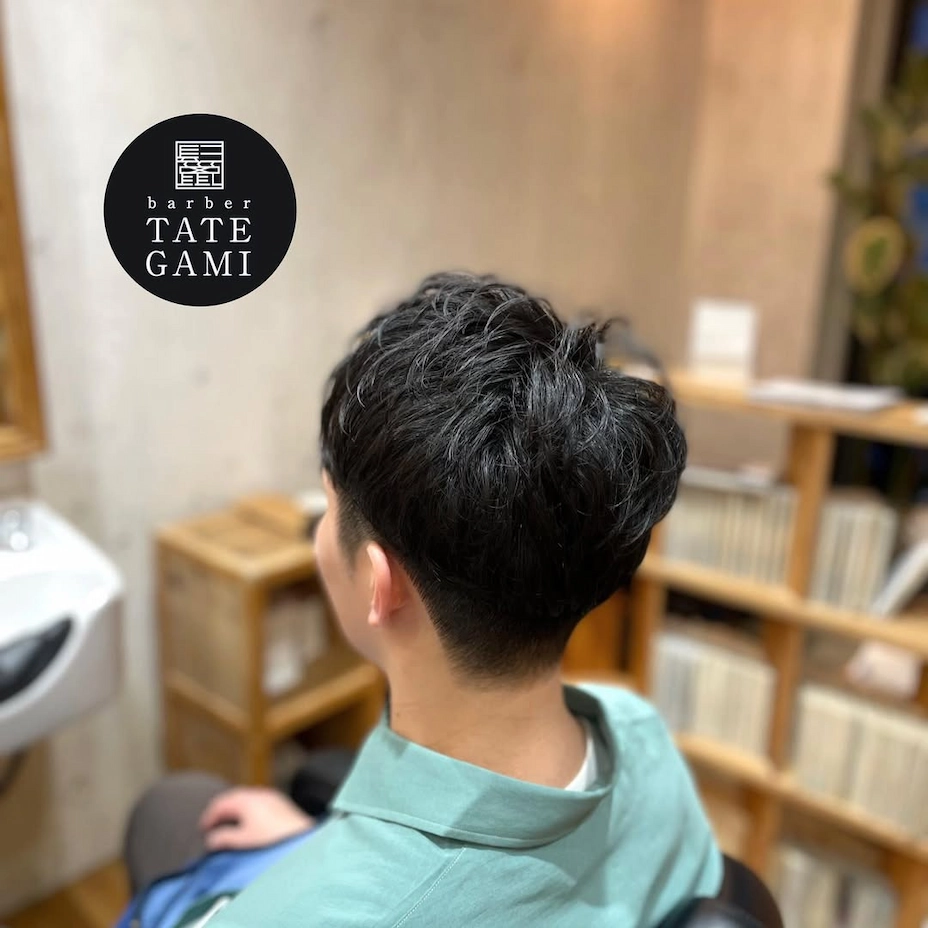 Client sitting in the barber chair with a fresh fade and clean style