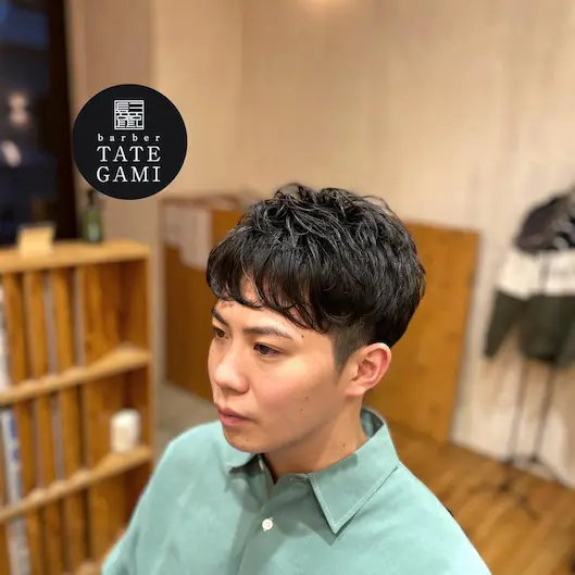 Client sitting in the barber chair with a fresh fade and clean style