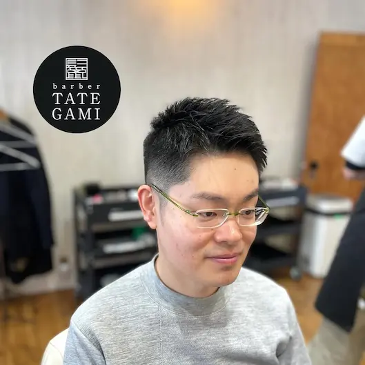 Client sitting in the barber chair with a fresh fade and clean style