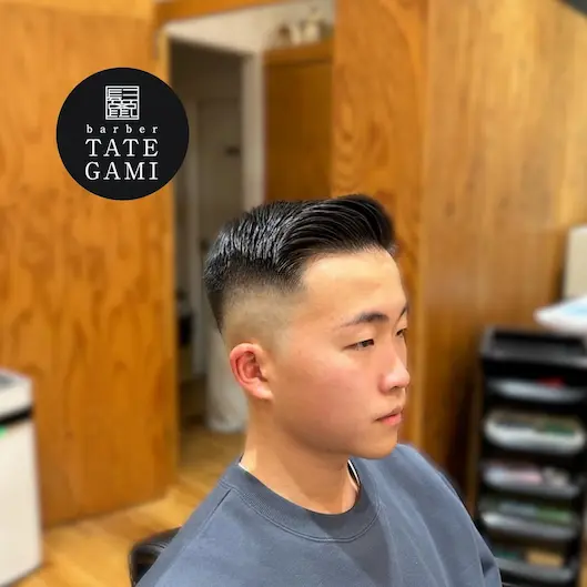 Client sitting in the barber chair with a fresh fade and clean style