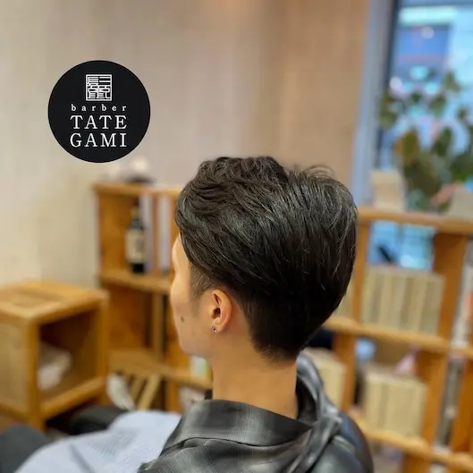 Client sitting in the barber chair with a fresh fade and clean style