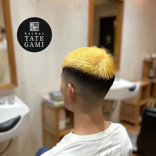 Client sitting in the barber chair with a fresh fade and clean style