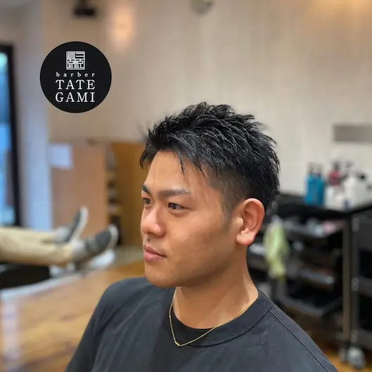Client sitting in the barber chair with a fresh fade and clean style